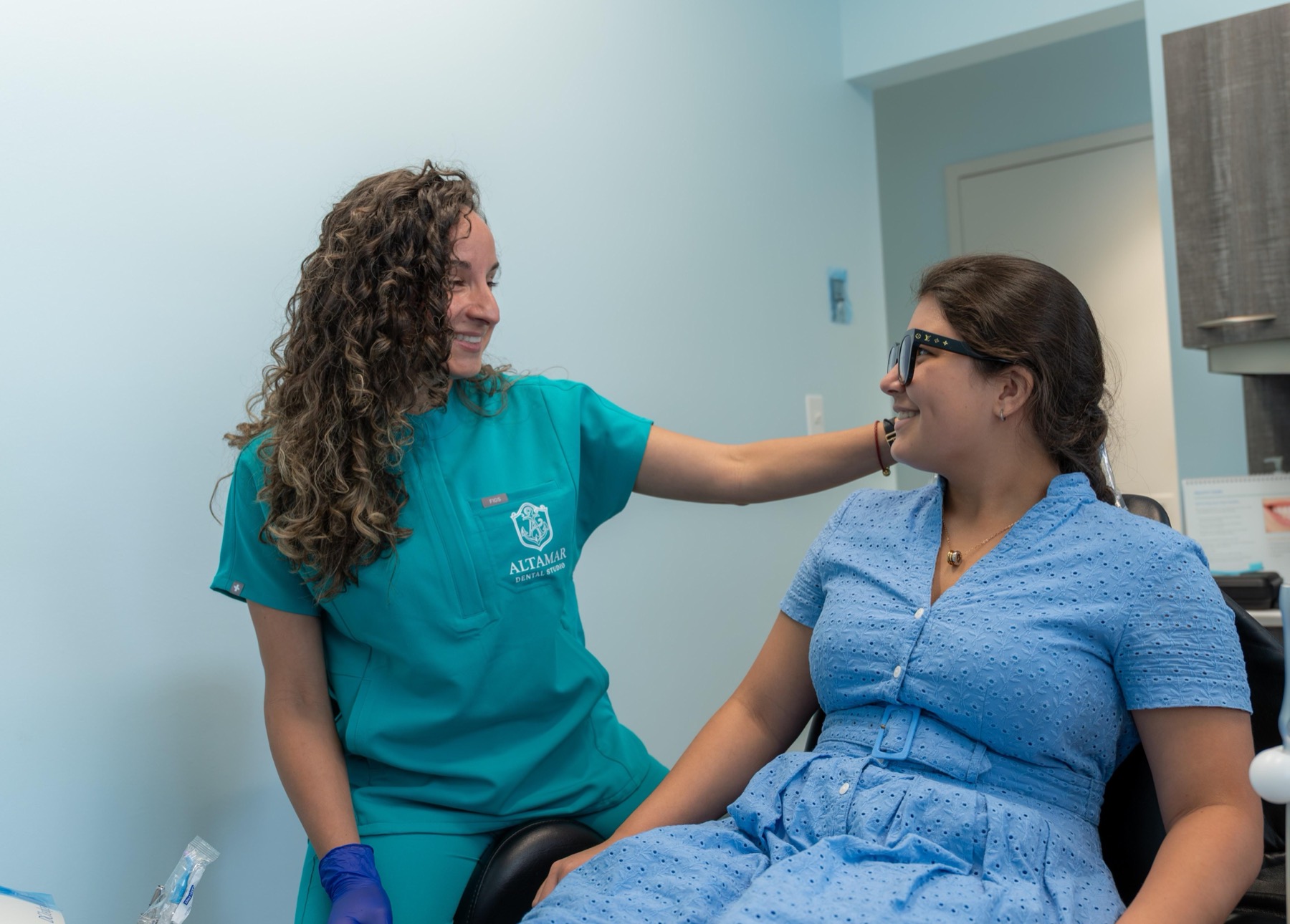 Dental hygienist Dani sharing a laugh with a patient at Altamar Dental Studio