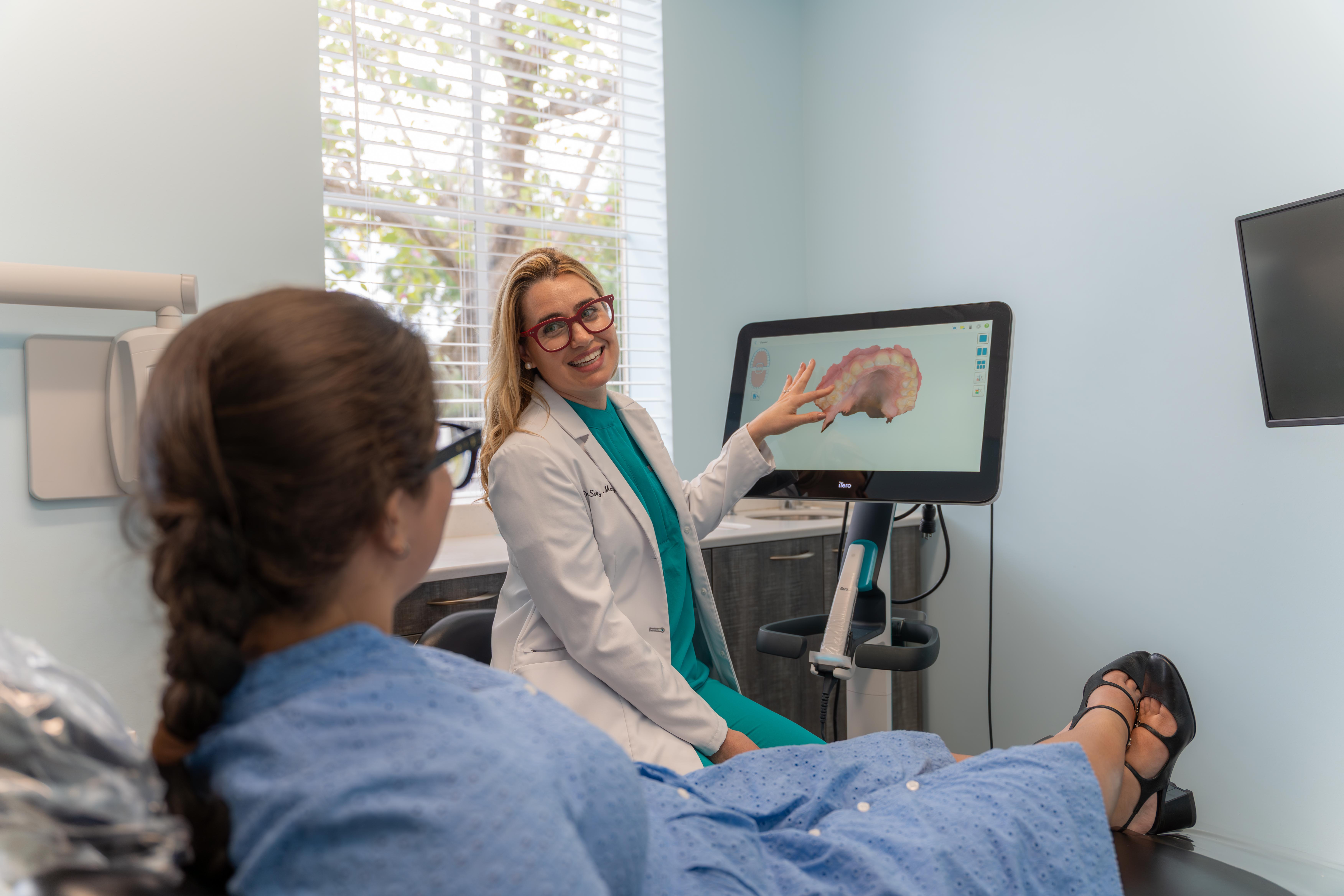 Doctor consulting with patient at Altamar Dental Studio